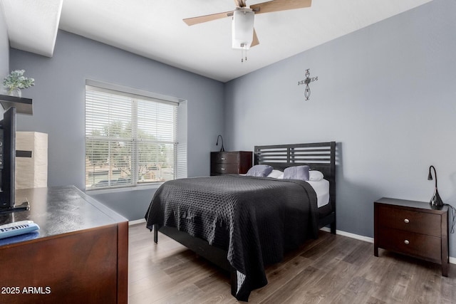 bedroom featuring baseboards, a ceiling fan, and wood finished floors