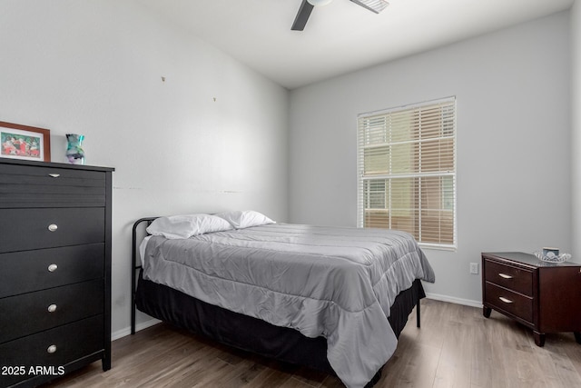 bedroom with baseboards, ceiling fan, and wood finished floors