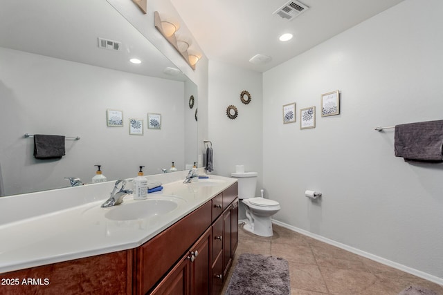 bathroom with toilet, baseboards, visible vents, and a sink