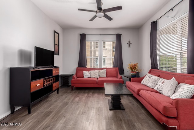 living area with a ceiling fan, a healthy amount of sunlight, and wood finished floors
