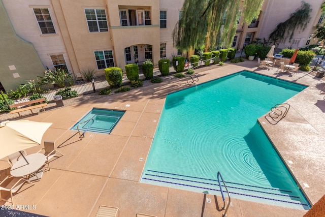 pool with fence and a patio