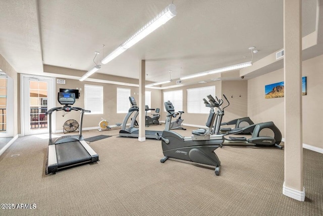gym featuring baseboards, carpet, and visible vents