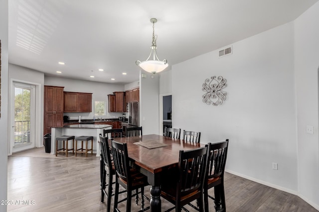 dining space with recessed lighting, visible vents, a wealth of natural light, and light wood-type flooring