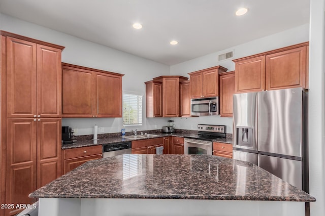 kitchen featuring visible vents, recessed lighting, brown cabinets, a sink, and stainless steel appliances