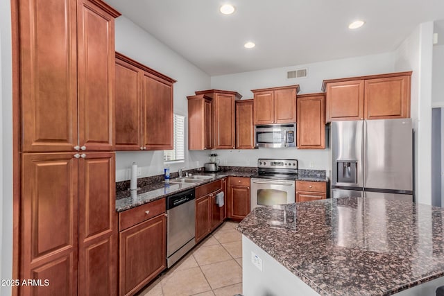 kitchen with visible vents, a sink, brown cabinets, and stainless steel appliances