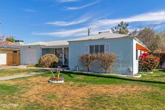 ranch-style home with an attached garage, a front yard, and stucco siding