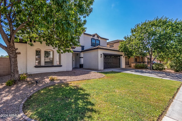 mediterranean / spanish-style home featuring a front lawn and a garage