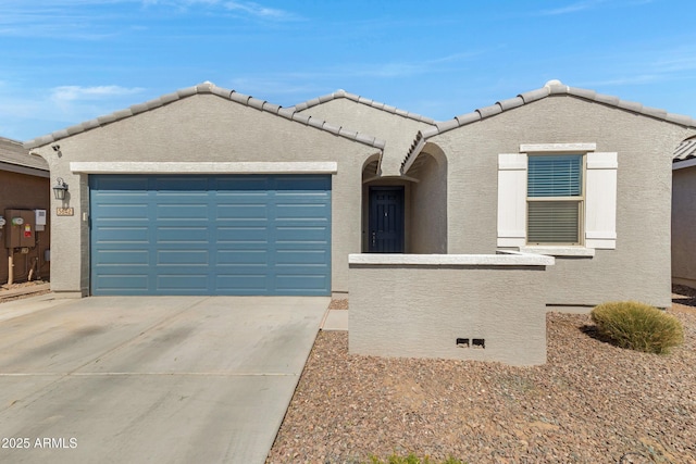 view of front of house featuring an attached garage, a tile roof, concrete driveway, and stucco siding