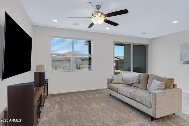 living room featuring recessed lighting, light colored carpet, visible vents, and baseboards