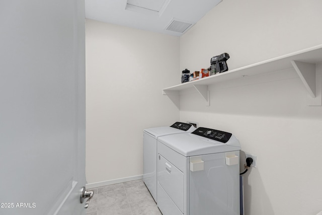 laundry area with laundry area, visible vents, baseboards, washing machine and clothes dryer, and attic access