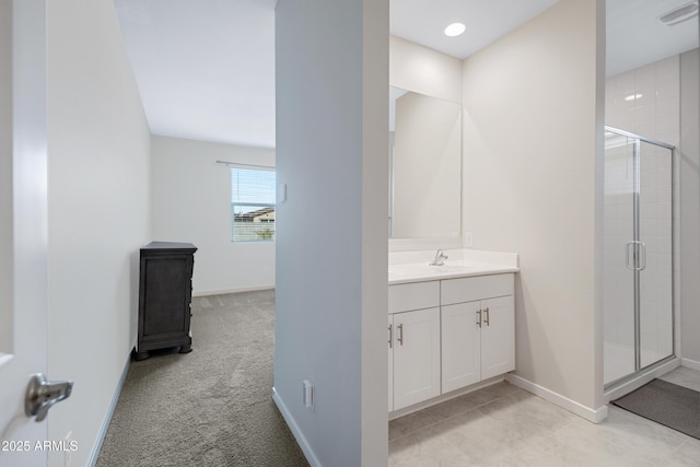 full bathroom with visible vents, baseboards, a shower stall, and vanity