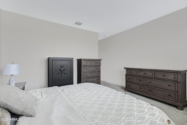 bedroom with baseboards, visible vents, and light colored carpet