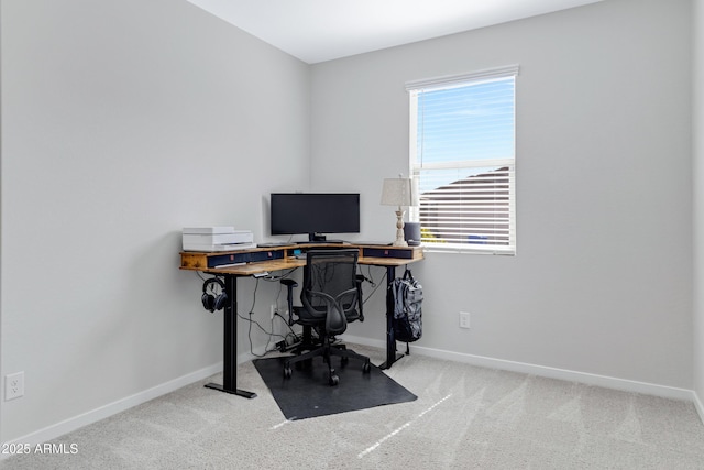 carpeted office featuring baseboards