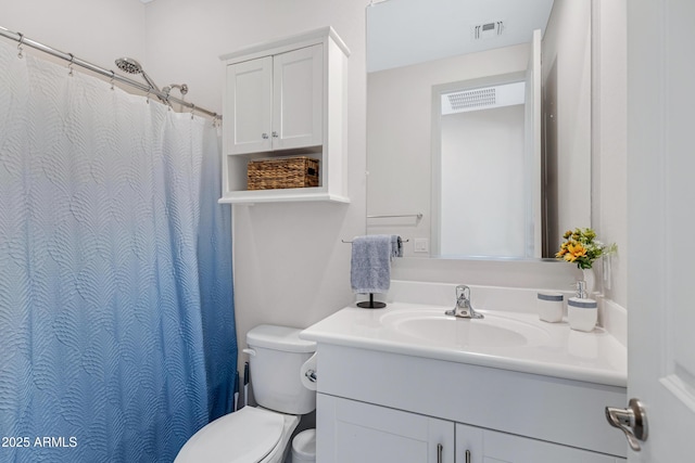 bathroom featuring toilet, visible vents, and vanity