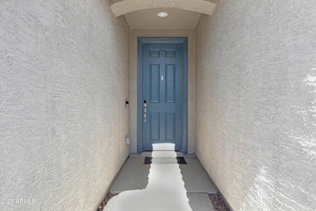 property entrance with stucco siding