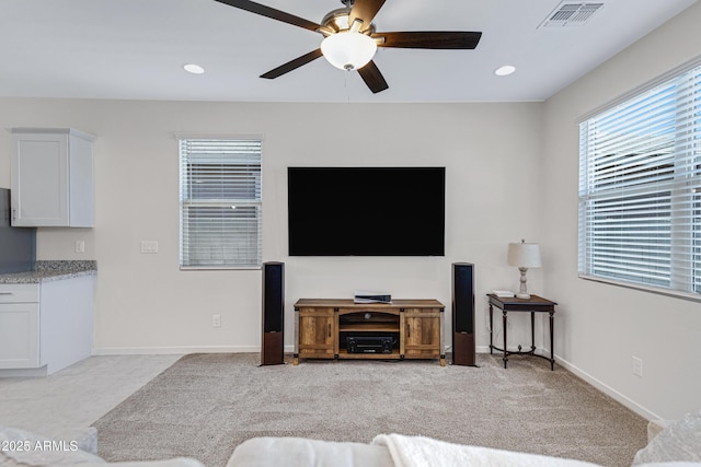 living area with a ceiling fan, recessed lighting, visible vents, and baseboards