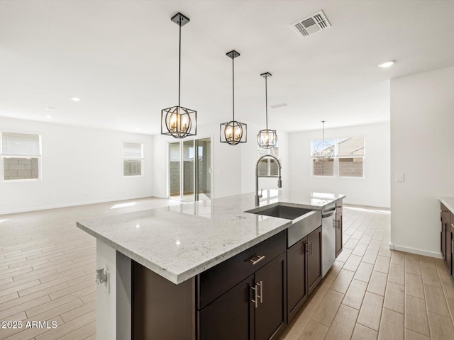 17703 W Southgate Ave, Goodyear, AZ 85338 - kitchen with a chandelier, visible vents, wood finish floors, and stainless steel dishwasher