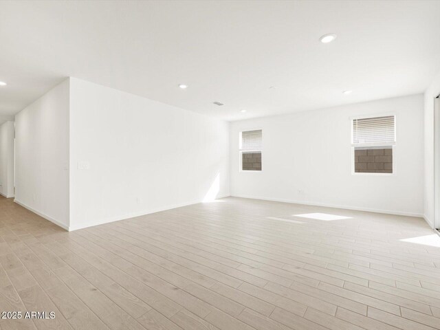 17703 W Southgate Ave, Goodyear, AZ 85338 - spare room featuring light wood-style flooring, recessed lighting, and baseboards
