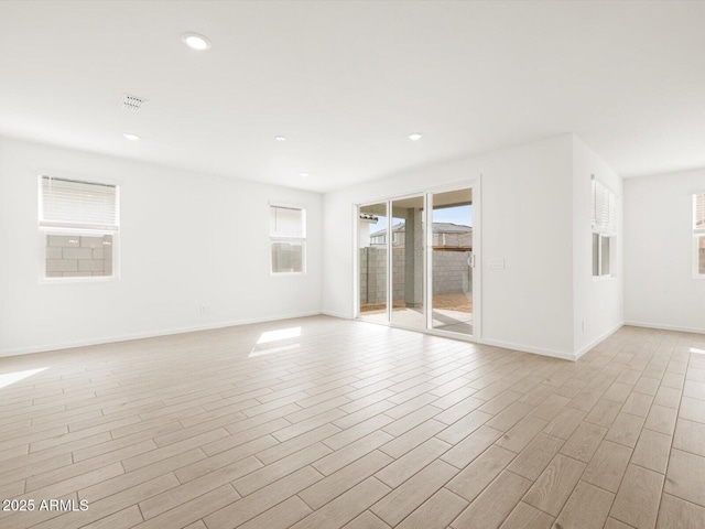 17703 W Southgate Ave, Goodyear, AZ 85338 - empty room with light wood finished floors, visible vents, recessed lighting, and baseboards