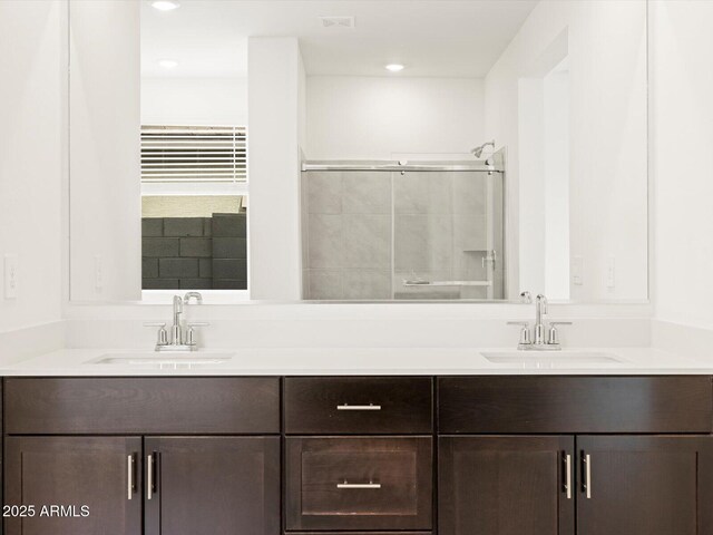 17703 W Southgate Ave, Goodyear, AZ 85338 - full bathroom with double vanity, a tile shower, and a sink