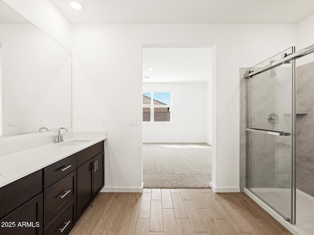 17703 W Southgate Ave, Goodyear, AZ 85338 - full bath with a shower stall, vanity, baseboards, and wood finished floors