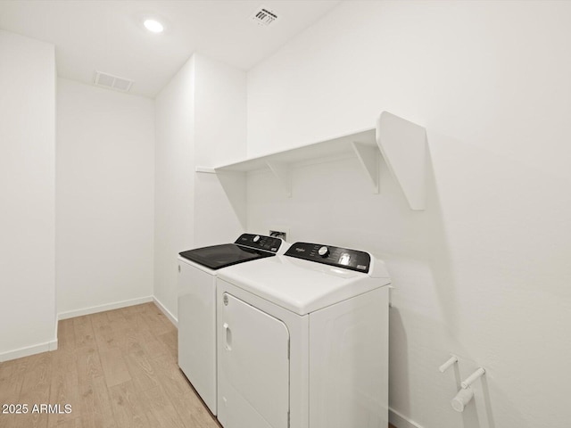 17703 W Southgate Ave, Goodyear, AZ 85338 - washroom with visible vents, baseboards, laundry area, light wood-style floors, and independent washer and dryer