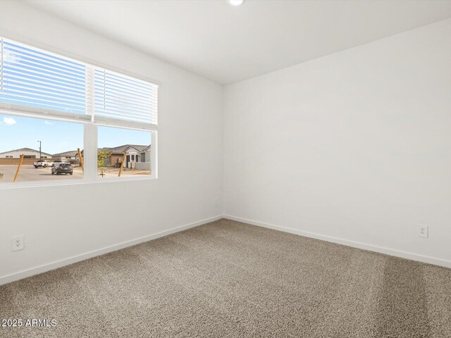 17703 W Southgate Ave, Goodyear, AZ 85338 - carpeted empty room with baseboards