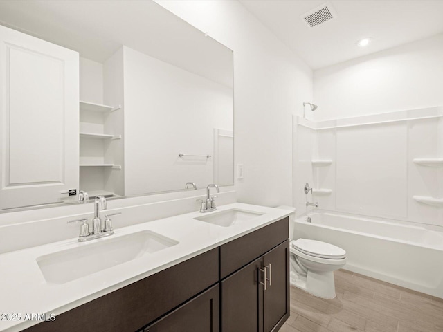 17703 W Southgate Ave, Goodyear, AZ 85338 - bathroom featuring bathtub / shower combination, toilet, visible vents, and a sink