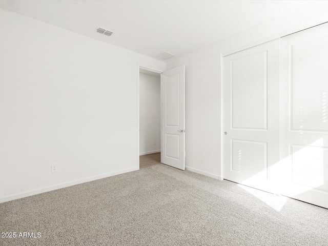 17703 W Southgate Ave, Goodyear, AZ 85338 - unfurnished bedroom with a closet, visible vents, baseboards, and carpet floors