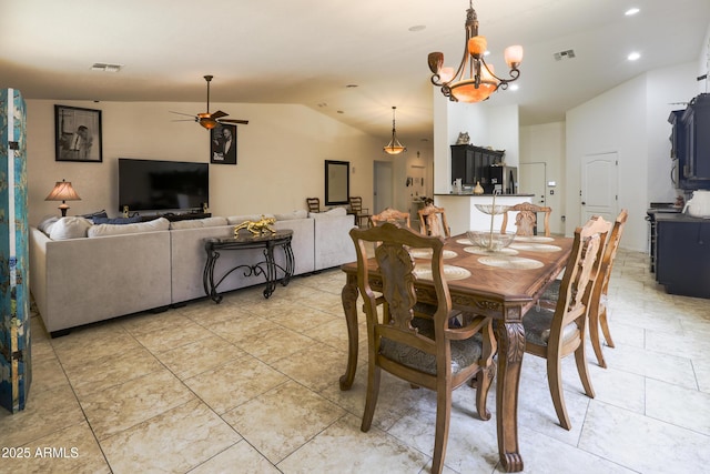 dining room featuring lofted ceiling, ceiling fan with notable chandelier, visible vents, and recessed lighting