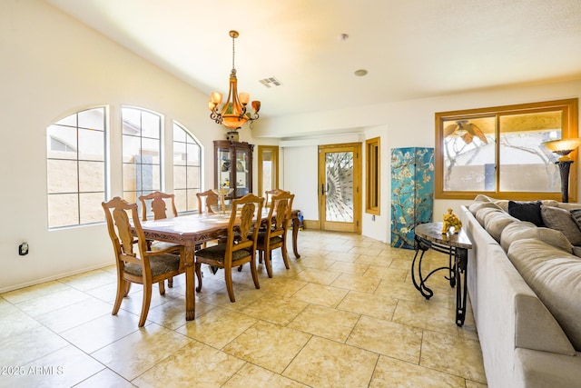 dining area featuring visible vents, baseboards, and an inviting chandelier