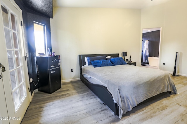 bedroom featuring wood finished floors and baseboards