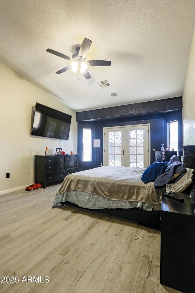 bedroom featuring multiple windows, wood finished floors, and visible vents