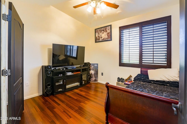 bedroom with wood finished floors, a ceiling fan, and baseboards