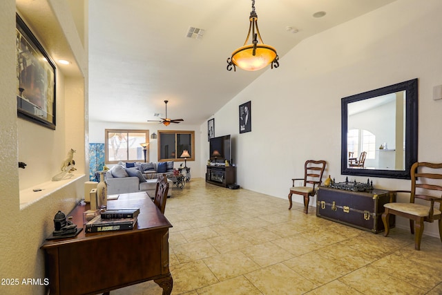 living area featuring a ceiling fan, lofted ceiling, and visible vents