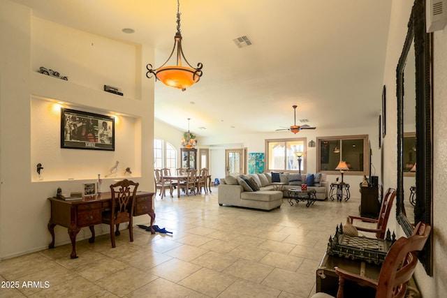 living room with a healthy amount of sunlight, ceiling fan, and visible vents