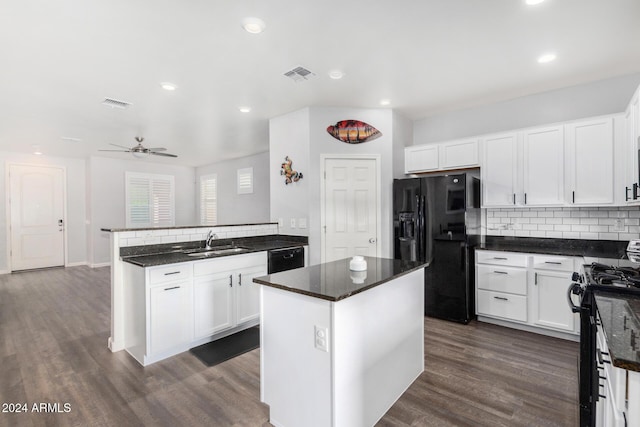 kitchen with kitchen peninsula, a kitchen island, ceiling fan, black appliances, and white cabinetry