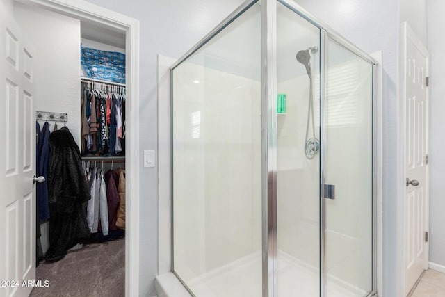 bathroom featuring a shower with door