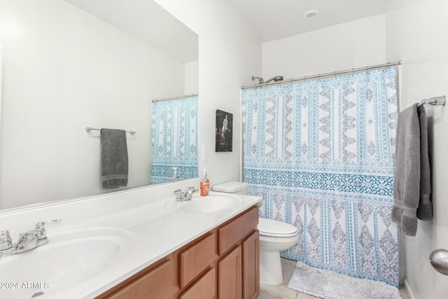 bathroom featuring curtained shower, tile patterned flooring, vanity, and toilet