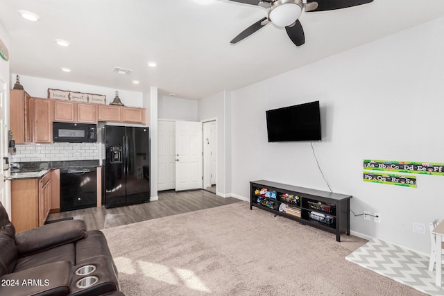 living room featuring hardwood / wood-style floors and ceiling fan