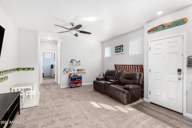 living room with ceiling fan and light carpet