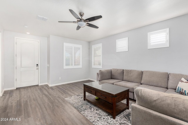 living room with hardwood / wood-style flooring and ceiling fan