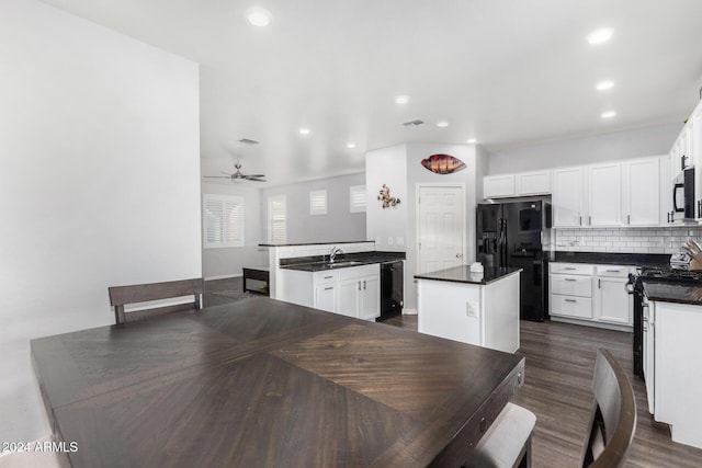 dining space with ceiling fan, dark wood-type flooring, and sink