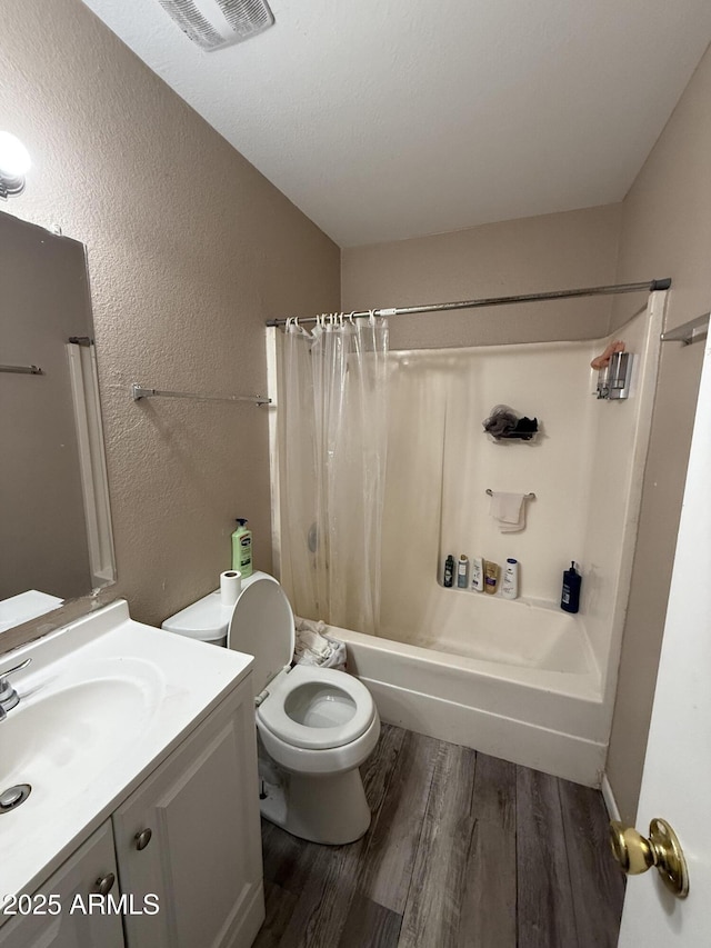 full bathroom featuring hardwood / wood-style flooring, vanity, toilet, and shower / bath combo with shower curtain