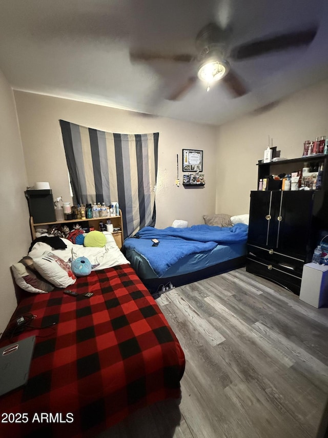 bedroom with hardwood / wood-style flooring and ceiling fan