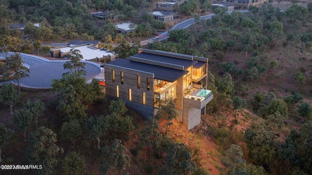 birds eye view of property with a view of trees