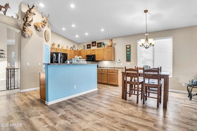 21604 E Calle De Flores, Queen Creek, AZ 85142 - kitchen featuring vaulted ceiling, light wood-type flooring, an inviting chandelier, hanging light fixtures, and black appliances