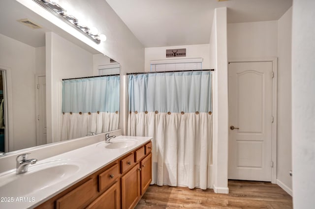 21604 E Calle De Flores, Queen Creek, AZ 85142 - full bath featuring double vanity, visible vents, wood finished floors, and a sink