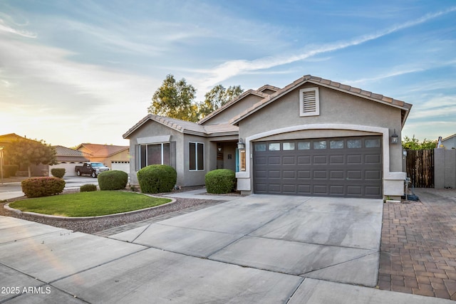 21604 E Calle De Flores, Queen Creek, AZ 85142 - ranch-style home featuring a tile roof, concrete driveway, stucco siding, fence, and a garage