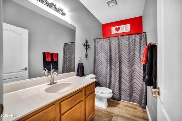 21604 E Calle De Flores, Queen Creek, AZ 85142 - full bath featuring vanity, toilet, a shower with shower curtain, visible vents, and wood finished floors